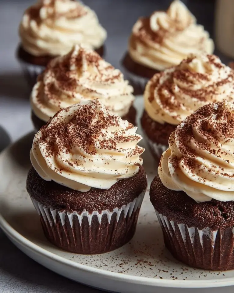 Delicious chocolate tiramisu cupcakes topped with cocoa powder and chocolate shavings.