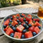Refreshing berry watermelon salad served in a bowl, ideal for summer picnics